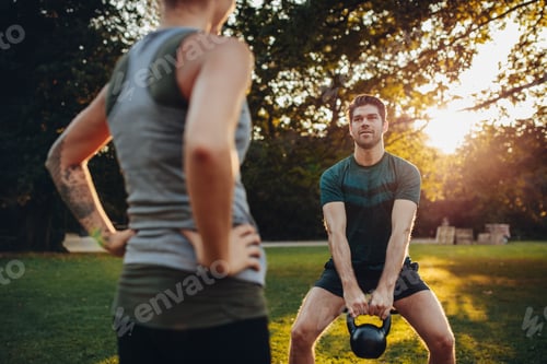 Preview: Fitness man exercising with personal trainer