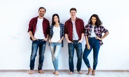 Preview: The four happy people standing on the white wall background