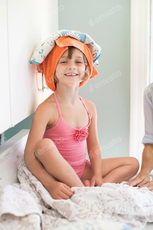Preview: Girl with towel on head smiling, portrait