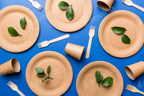 Preview: set of empty reusable disposable eco-friendly plates, cups, utensils on light table background