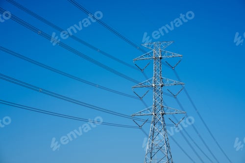 Preview: Electric pole with wires against a blue sky, showing power lines in close up.
