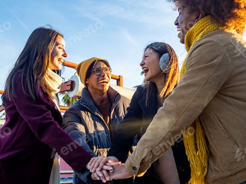 Preview: Group of diverse friends put their hands together and celebrate christmas holidays