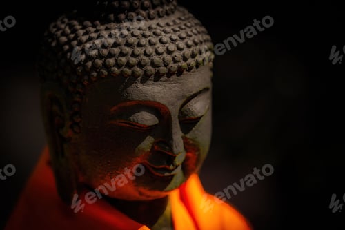 Preview: Closeup of Buddha sculpture in dim lighting