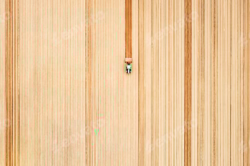Preview: Lonely tractor on agricultural field with rows of plowed soil