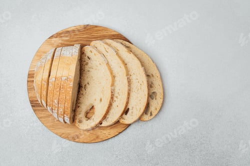 Preview: Slices of fresh bread arranged neatly on a wooden cutting board