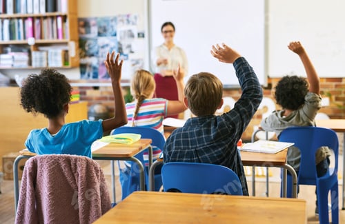 Preview: Students raising hands in a classroom with teacher