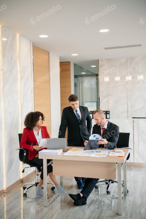 Preview: Group of young business people discussing business plan at modern startup in creative business