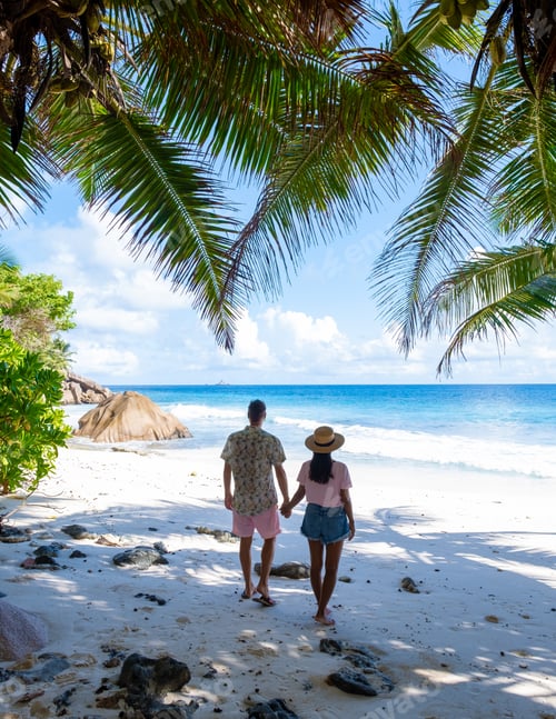 Preview: Anse Lazio Praslin Seychelles, a young couple of men and women on a tropical beach during vacation