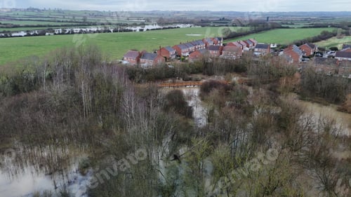 Preview: view from above of the water and fields near houses, trees and bushes
