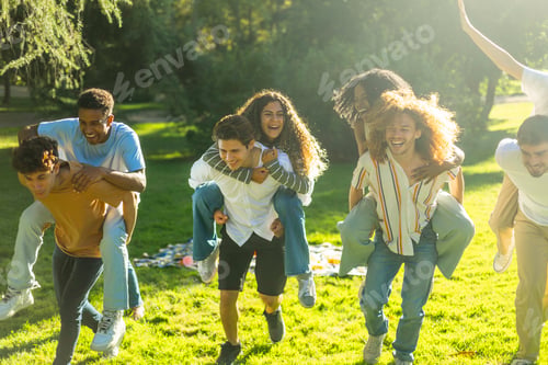 Preview: Group of friends running through park giving piggyback rides