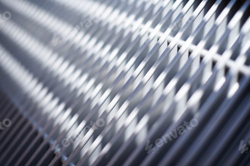 Preview: Grill of heating radiator in office, close up. White heat exchangers. Iron aluminium lattice