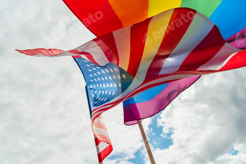 Preview: bottom view of american and colorful lgbt flags against sky