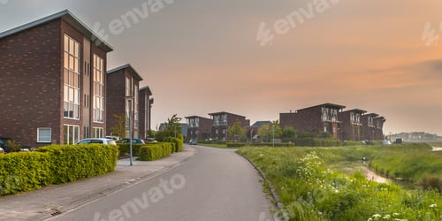 Modern Suburban Homes at Dusk with Golden Sky