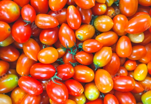 Preview: Pile of colorful cherry tomatoes background for sale in local market, top view and full frame
