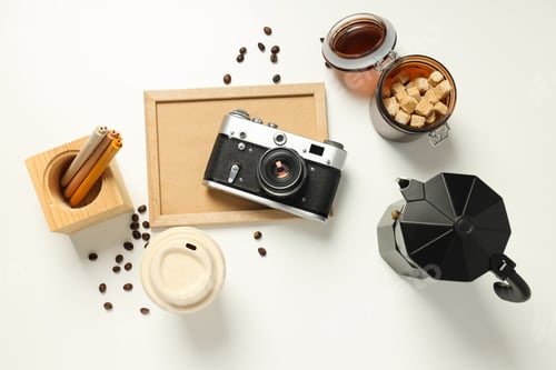 Preview: Vintage camera, coffee and photo frame on white background, top view