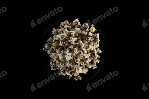 Preview: top view of salty popcorn isolated on black