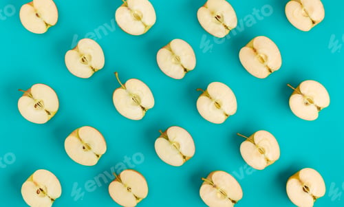 Preview: Fruit pattern of apple halves on blue background. Flat lay, top view. Food background.