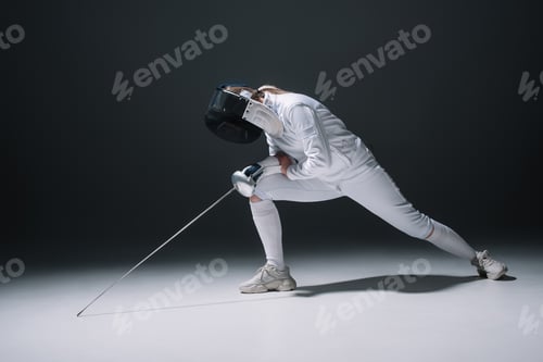 Preview: Fencer doing lunge while holding rapier on white surface on black background