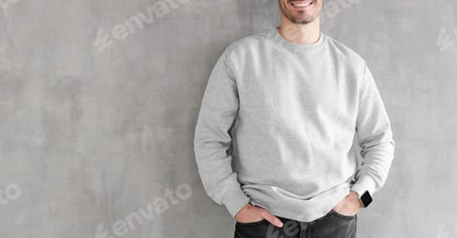 Preview: Mock up of young man body in empty sweatshirt isolated on textured gray wall background