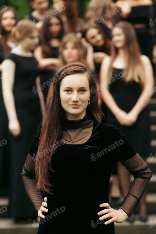 Preview: luxury gorgeous woman in black dress posing, standing in front of group of ladys