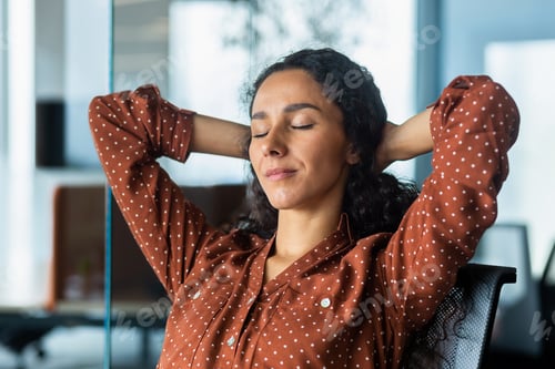 Preview: Hispanic business woman with closed eyes dreaming at workplace, close-up female worker with hands