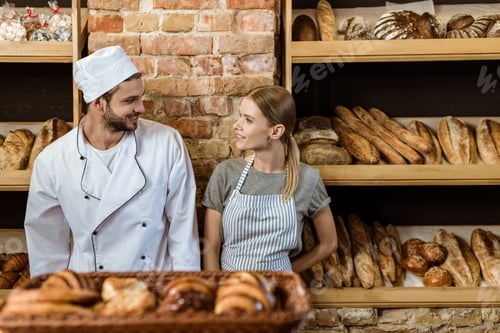 Preview: couple of young bakers standing at pastry store