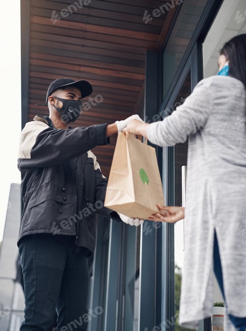 Preview: Shot of a masked young woman receiving a takeout delivery at home