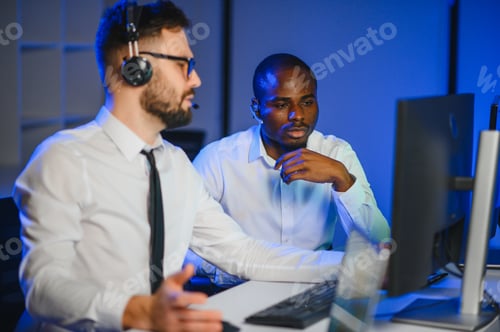 Preview: Diverse call center operators team use computers consulting clients in office