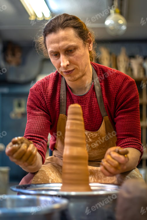 Preview: A man is making pottery on a potter's wheel. A man makes pottery. Clay modeling.