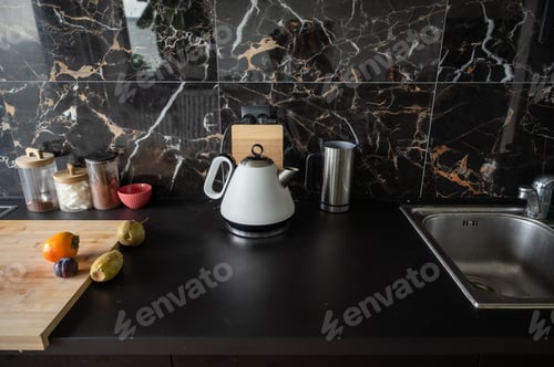 Preview: White electric kettle in a black kitchen