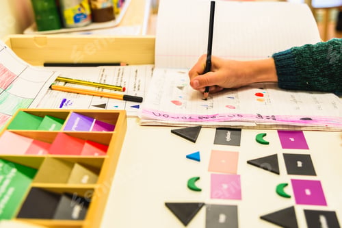 Preview: Elementary pupil writing in a notebook, homeschooling concept.