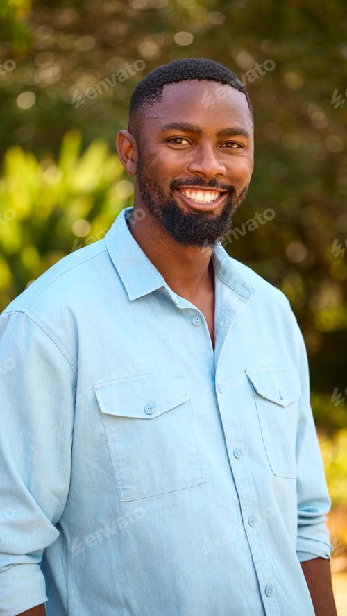 Preview: Portrait Of Laughing And Smiling Man Standing Outdoors In Countryside