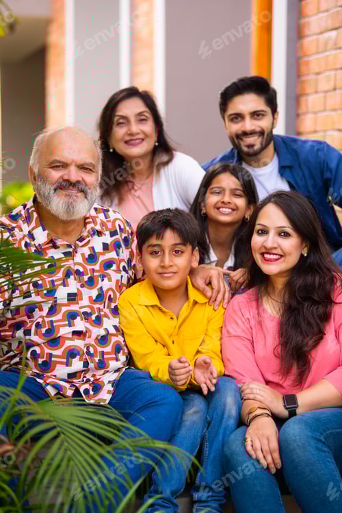 Preview: Indian family enjoying outdoor bonding time on steps during weekend relaxation
