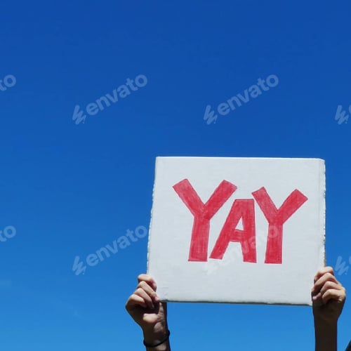 Preview: Yay,hands holding sign up in the air against clear blue sky
