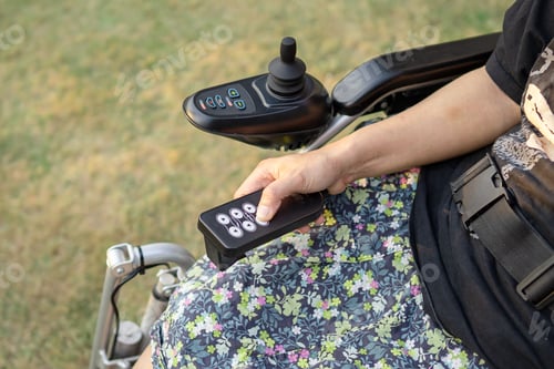 Preview: Asian lady woman patient on electric wheelchair with joystick and remote control