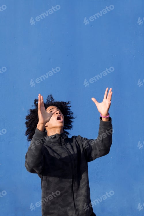 Preview: teen male with curly hair looking up surprised