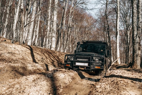 Preview: Offroad car driving through the forest road of mud