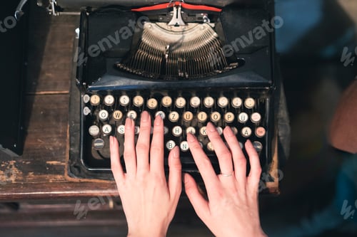 Preview: a female person typing text using and old typewriter machine