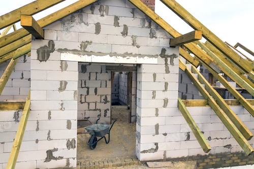 Preview: Aerial view of a private house with aerated concrete brick walls and wooden frame for future roof