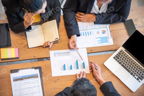 Preview: Corporate Team Analyzing Sales Data Together in Workplace