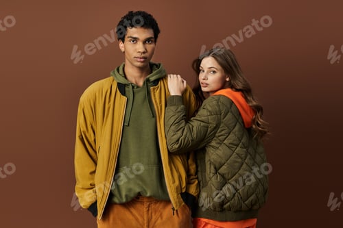 Preview: A stylish young couple embraces autumn fashion against a rich autumn backdrop