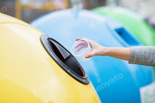 Preview: Garbage Recycle. Female throwing plastic food case container into yellow recycle bin