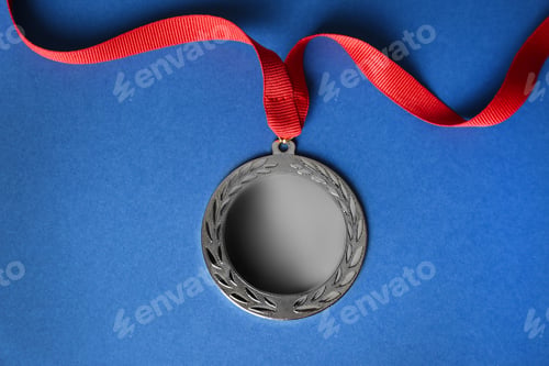 Preview: Silver medal on blue background, top view. Space for design