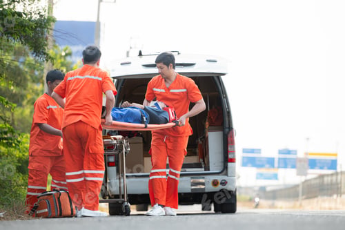 Preview: The paramedic is assisting an injured man in an emergency situation on the road.