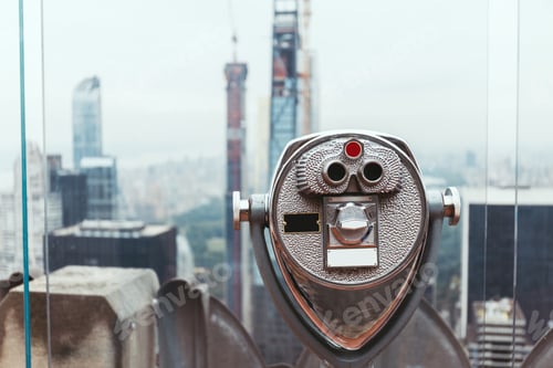 Preview: close up view of operated binoculars on observation deck in new york city, usa