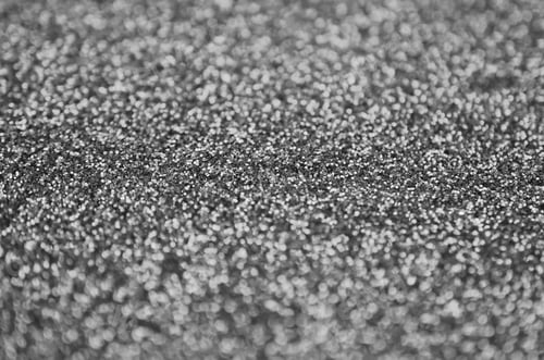 Preview: Silver decorative sequins. Background image with shiny bokeh lights from small elements