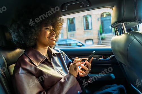 Preview: Young woman enjoying ride, checking smartphone in manhattan car