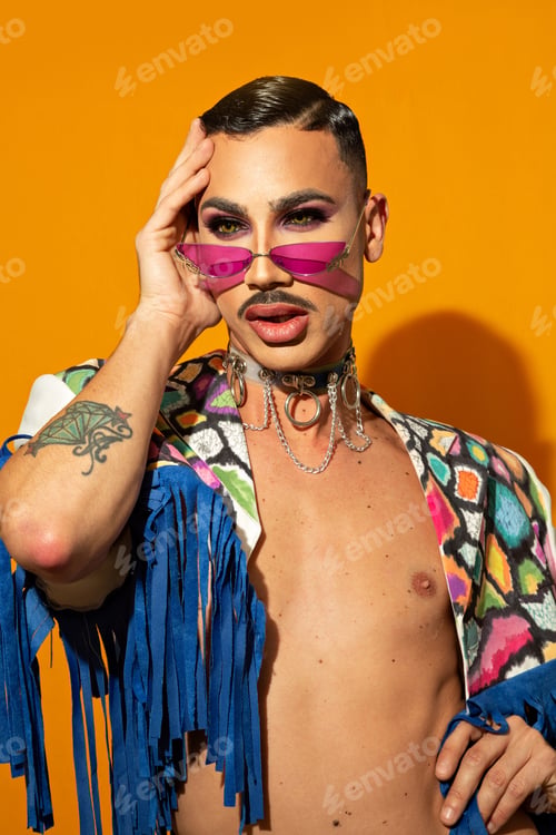 Preview: young drag queen in colorful dress on yellow background
