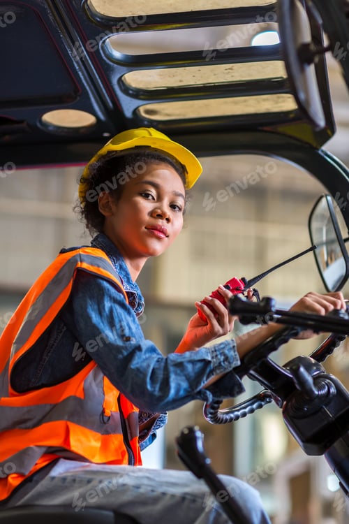 Preview: women worker at forklift driver happy working in industry factory logistic ship.