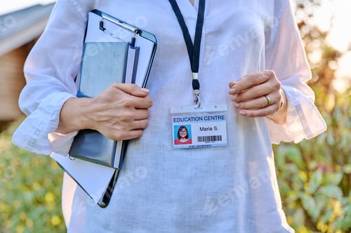 Preview: Close-up of badge on woman worker of educational center